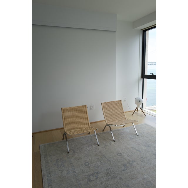 Poul Kjærholm, 1956 · Fritz Hansen A study in restraint. The PK22 pares the lounge chair down to two flat bands of satin-...