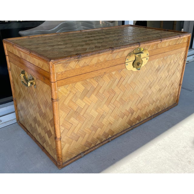 Lovely and timeless trunk from 70's. Chinoserie style made of solid wood, bamboo and wicker. Solid brass hardware....