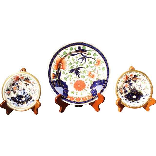 A charming trio of coordinating English Imari plates with gilding and with light blue and green details, Ca. 1810. The...