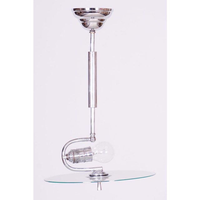 This chandelier is an iconic representative of Functionalist design and the Bauhaus movement in 1930s Czechoslovakia....