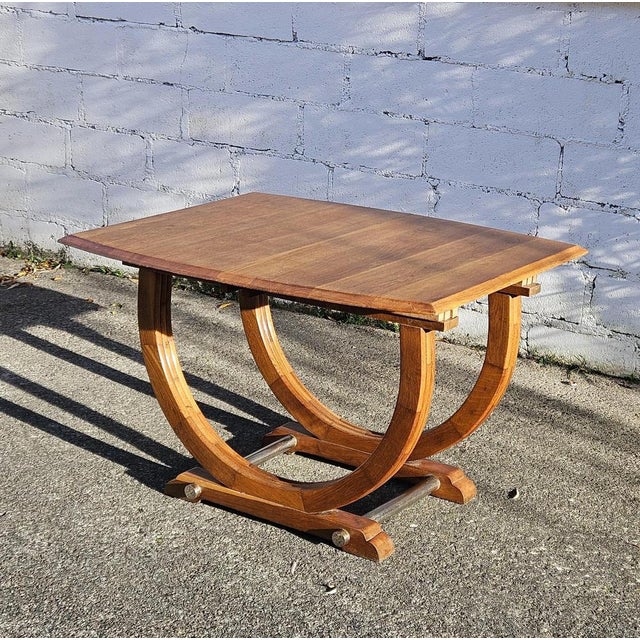 Gorgeous expandable Art Deco dining table from 1920s. This Table features a golden wood finish and exceptional...