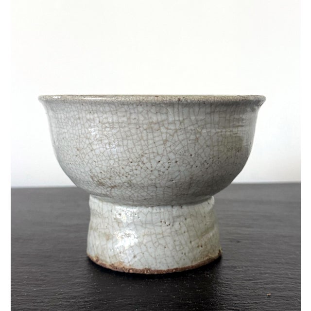 A celadon ceramic stem bowl with impressive patina from Korea, circa 17th centuries of mid Joseon Dynasty. With high...