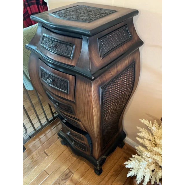 Striking Bombay-style tall chest of drawers featuring a dramatic serpentine silhouette with six graduated drawers. Each...