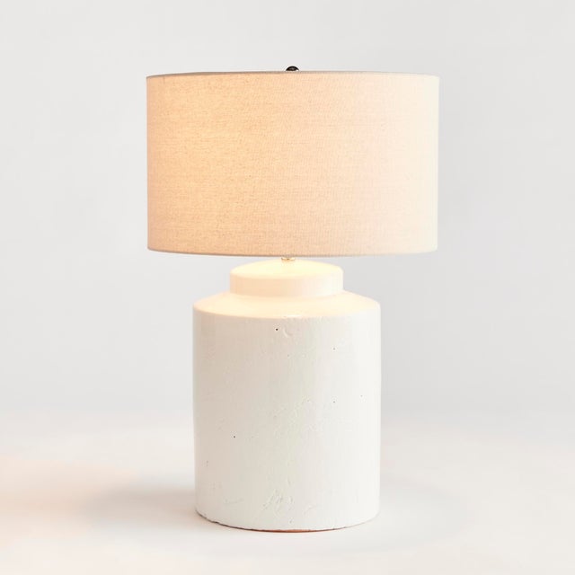 In a classicWhite ceramic with a thicklyapplied glaze, this lamp is made for the transitional setting. A generously...