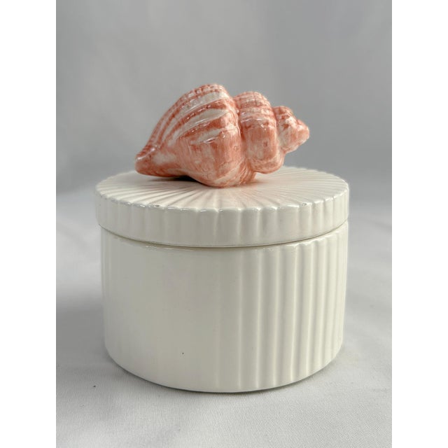 This is a charming Fitz and Floyd off white rounded sea shell ceramic box. The box is a scalloped design with a coral...
