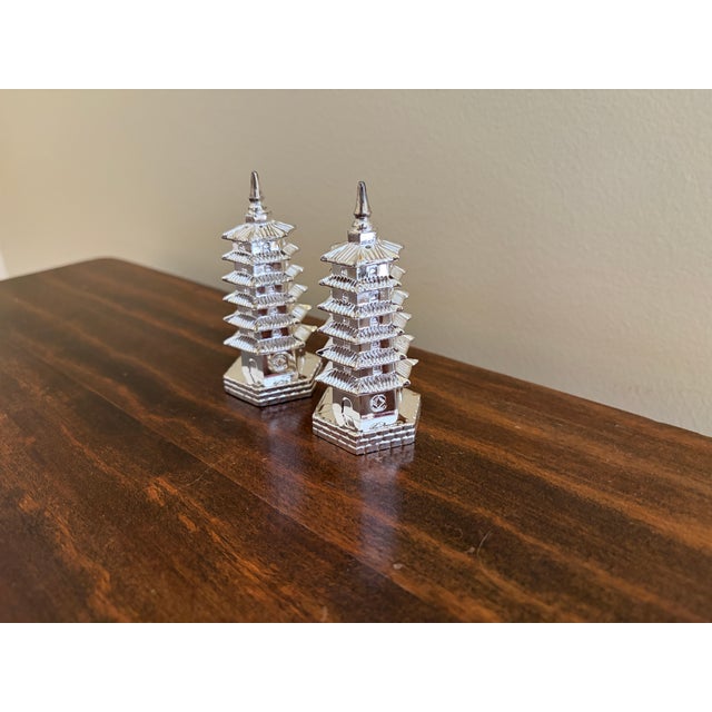 A wonderfully whimsical pair of circa 1970s Godinger salt and pepper shakers modeled as traditional tiered pagodas....