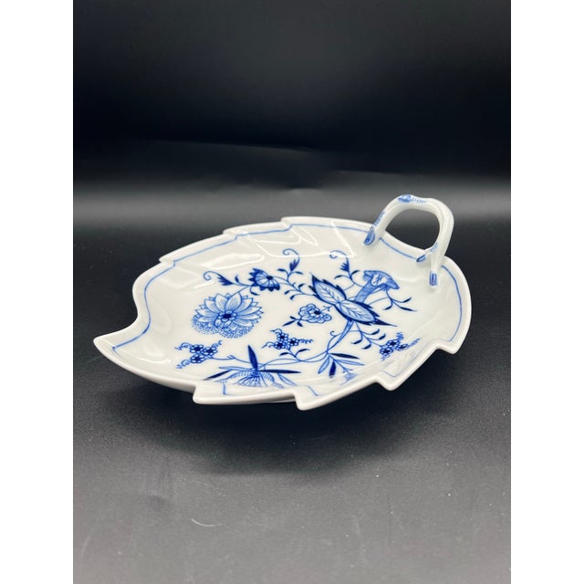 The Meissen Blue Onion Leaf Dish is an antique collectible serving plate made of porcelain, featuring a classic blue and...