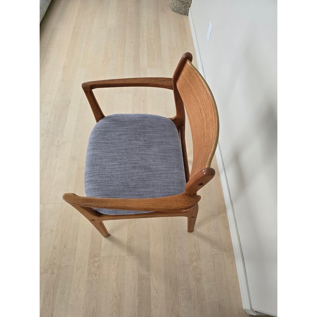 Vintage Danish Modern teak armchair made in Denmark, circa 1960s. This beautifully crafted chair features the sculptural...