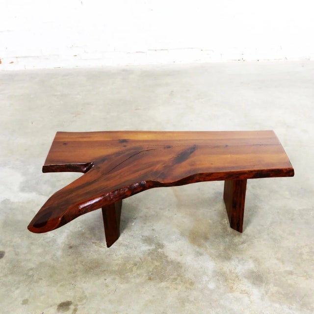 Incredible mid-century live edge or free edge solid slab coffee table or bench in the style of George Nakashima. It is in...
