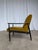 Vintage mid-century armchair made in Yugoslavia in the 1960s. The chair features a solid wooden base and yellow...