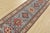 A tribal Caucasian Kazak runner hand-knotted with fine wool on a cotton foundation. This rug features a row of geometric...