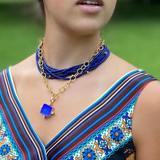 This lapis blue Italian glass features white topaz accents and an equestrian scene. Handmade. Intaglio from Italy and...