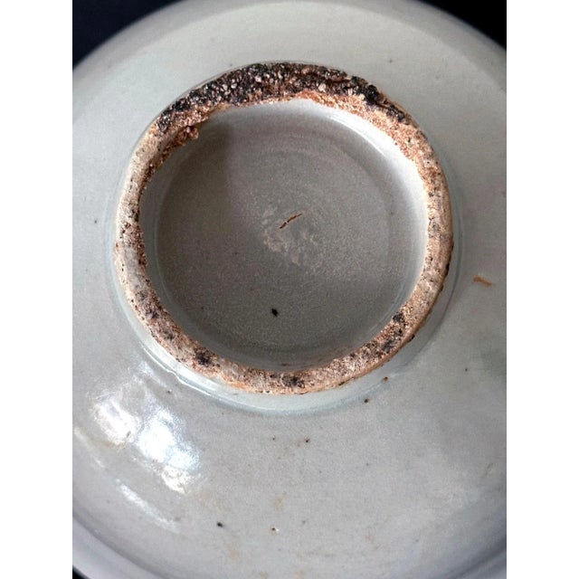 A Korean ceramic porcelain bowl covered in a white glaze with a hint of bluish green circa 18th century, possibly earlier,...