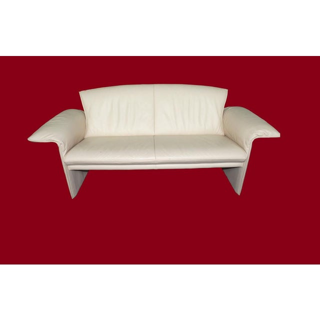 2 jori sofas manufactured in very elegant, petite design made of high quality leather in cream white. The armrests are...