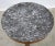 A striking 19th-century French Empire center table featuring a circular gray marble top with dramatic white veining and a...