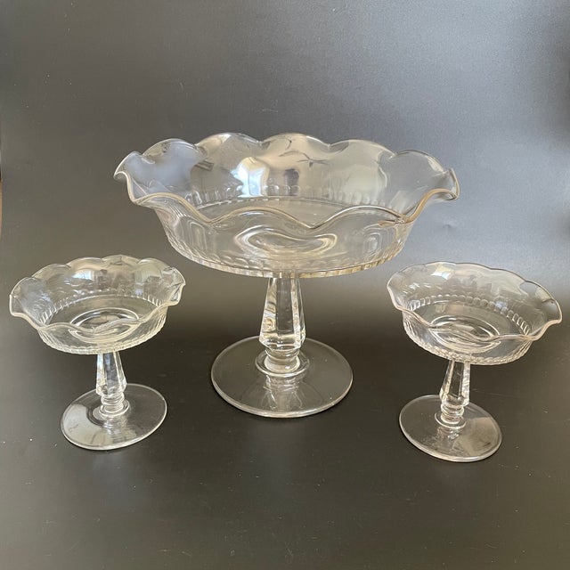 This open compote set includes one large comport and two smaller ones. Each piece features a softly flared and ruffled...
