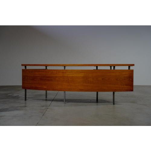 Teak desk by Pander. The desk is in good condition with marks of usage normal to it´s age. This boomerang-shaped desk was...
