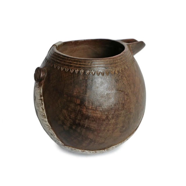 Vintage handmade village pitcher from North Africa. Rich dark wood with original aluminum repairs and traditional...