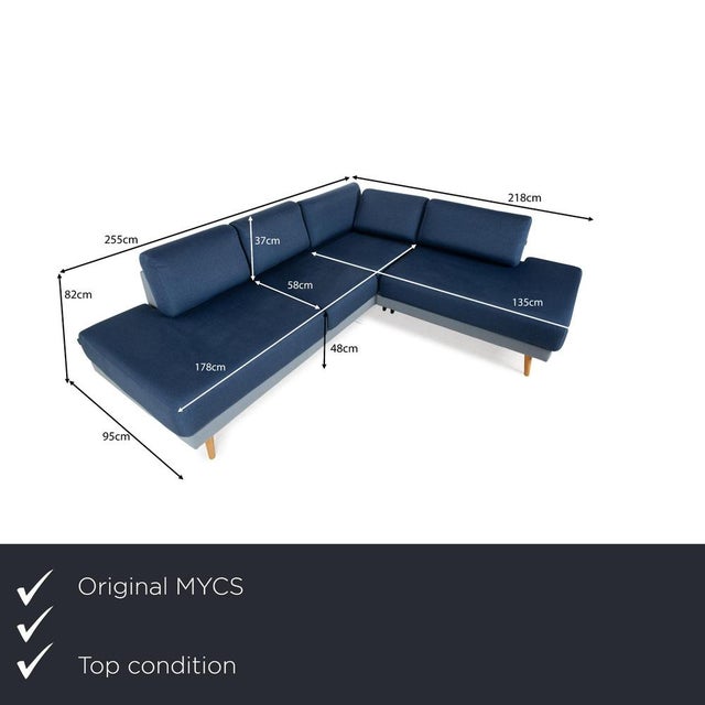 The TYME sofa by MYCS is covered in fabric in two different shades of blue and stands on narrow, tapered, minimally angled...