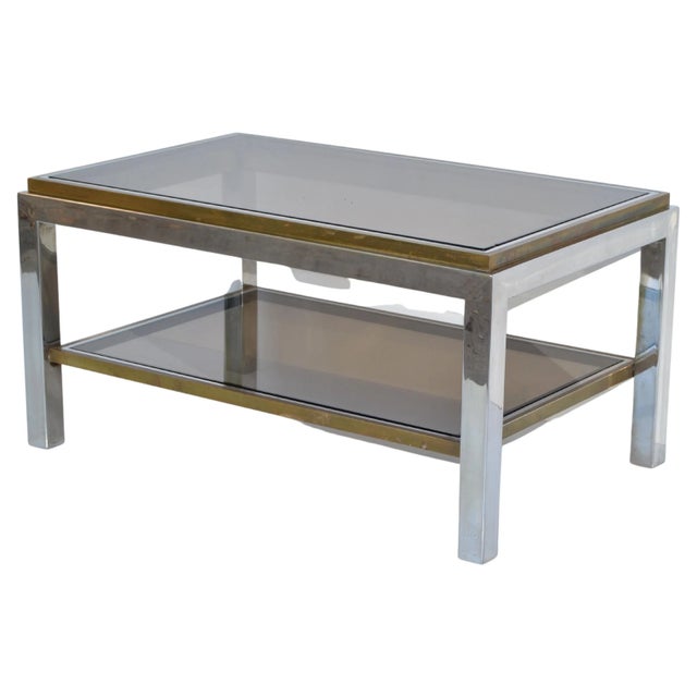Very elegant two-tier coffee table signed Willy Rizzo made in Italy, circa 1965. Sturdy chrome frame with brass inlay and...