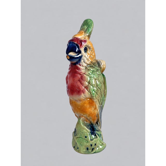 An exceptional early 20th-century French polychrome barbotine faience figural pitcher modeled as a crested parrot or...