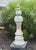 A tall, sculptural cast concrete finial with elegant tiered form and diamond-patterned detailing. The surface bears a...