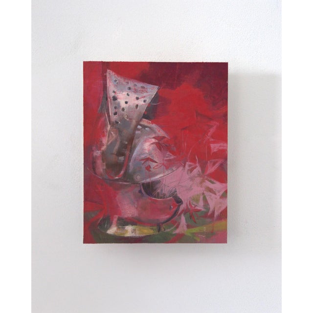 In "Memoriam," a solitary knight's helmet sits against a vibrant red backdrop, evoking a sense of nostalgia and...