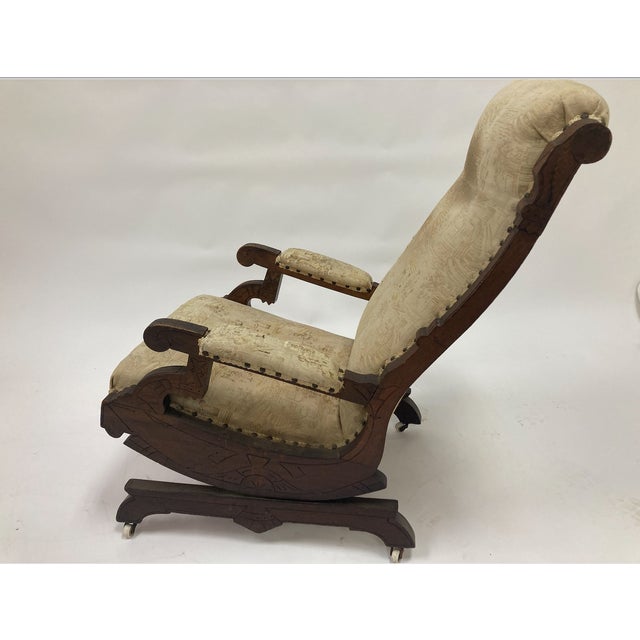 A distinctive Victorian Eastlake platform rocking chair, crafted in solid wood and dating to the late 19th century. This...