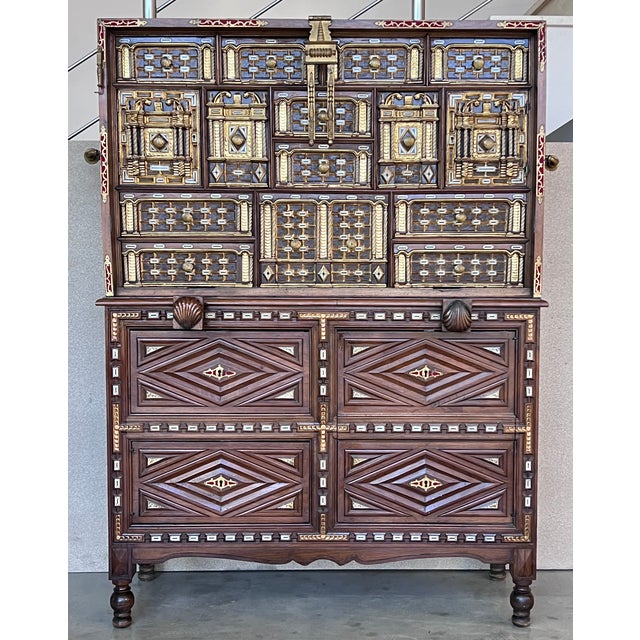 The rectangular locker rests on chest with legs, and has four drawers decorated with diamonds that lock and fittings and...
