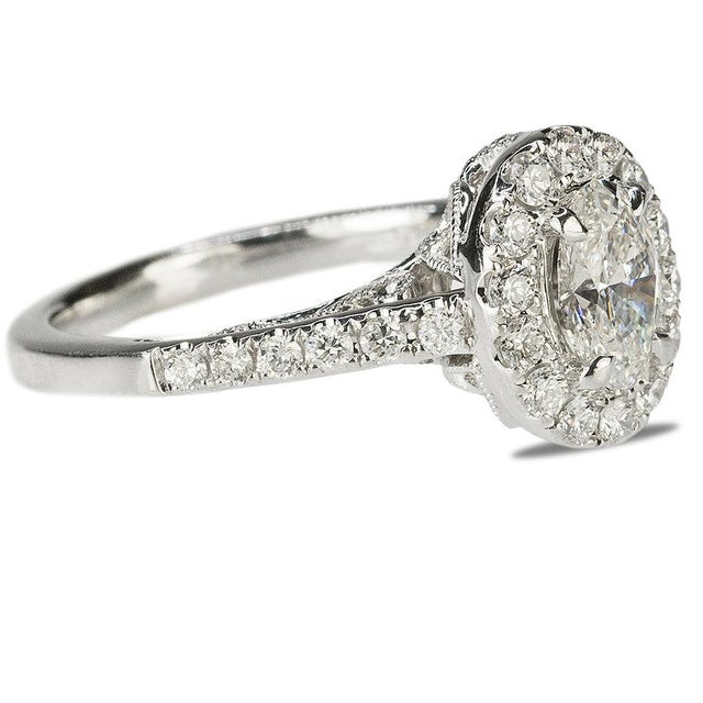 14k Ring with one approximate 0.75 carat oval diamond and 30 round brilliants weighing approxiamately 0.25 carats. 4.21g...