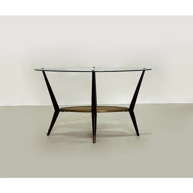 Unique tea or coffee table in the style of designer Gio Ponti, 1950, with a double top and four-legged frame made of black...