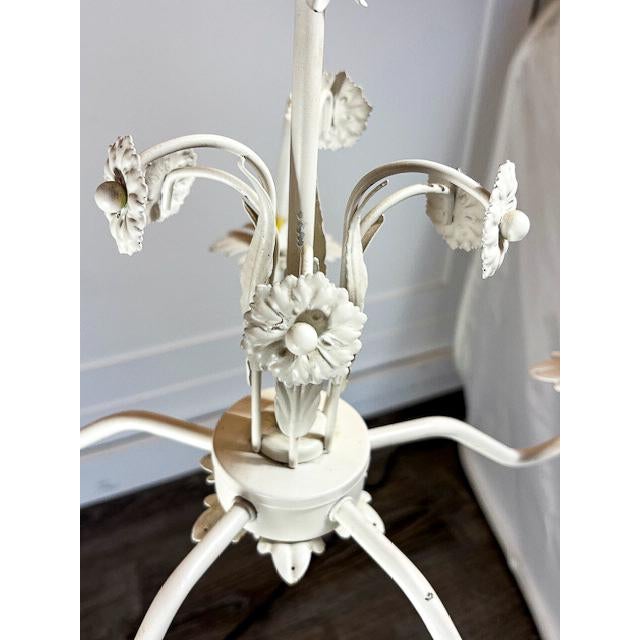 A charming tole chandelier with a painted white finish, bringing a soft, vintage feel to any space. It features four...