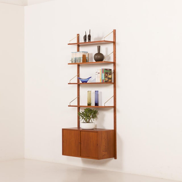 This teak wall unit was designed by poul cadovius for his company cado in the 1960s. Its simple form provides elegance as...