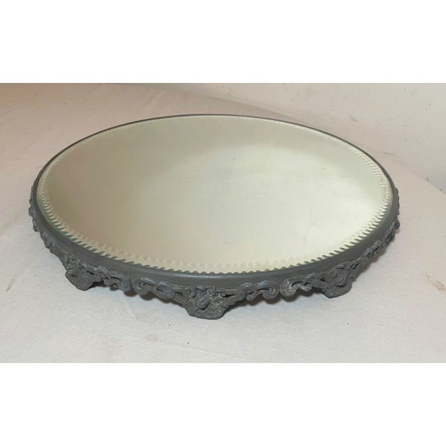 Up for sale is a wonderfully large antique round vanity table top mirror. It has a very ornate silver-plated edge that...
