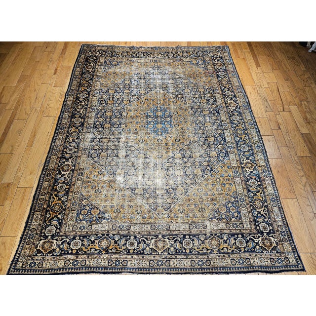 "A refined vintage Persian Tabriz rug from the early 20th century, this hand-knotted masterpiece features a classic Herati...