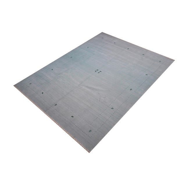 Make a bold statement in your living area with this exquisite Contemporary Gabbeh Wool Rug. It is meticulously hand-...