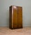 A 1930s Art Deco compact wardrobe in figured oak veneer with contrasting walnut trim, original handles, a pull-out rail...