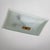 Large rectangular ceiling lamp featuring a curved frosted glass shade and a central brass mount with spherical detailing....