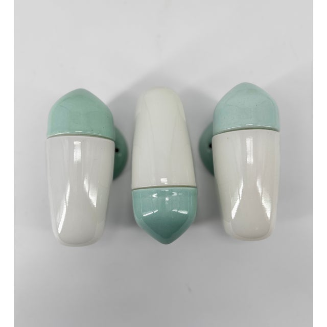 Wall light in blue green aqua porcelain and opaline glass shades were designed by the German designer Wilhelm Wagenfeld,...