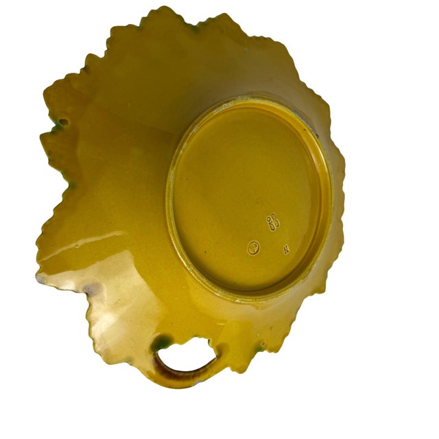 A beautifully modeled Villeroy & Boch majolica bowl featuring a sculptural leaf motif in rich green and brown glazes. The...