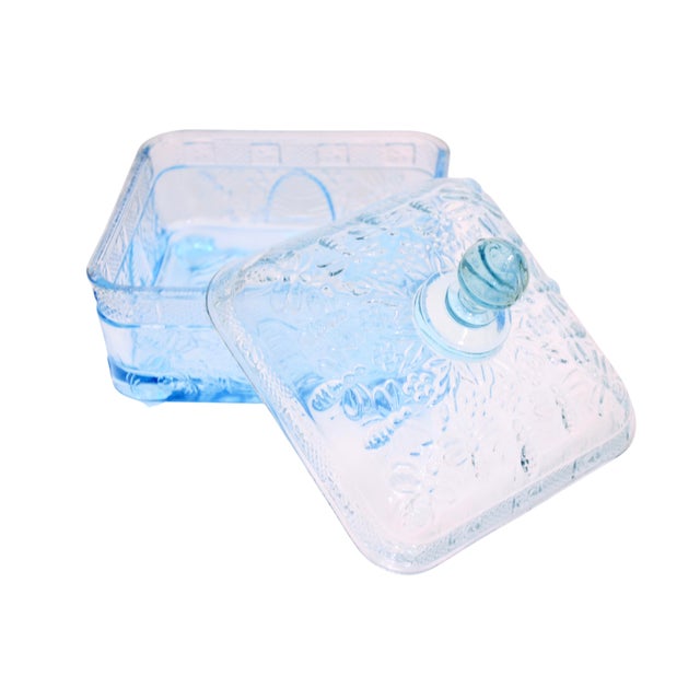 Vintage blue glass five inch square footed box with lid has a bee & honeycomb raised design. Slight color variance between...