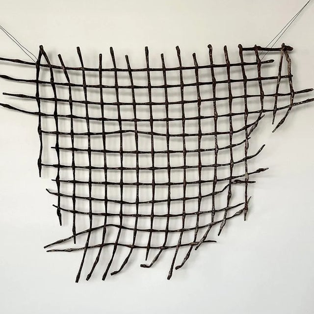 Antique, rusty iron grid is a special, unique wall sculpture