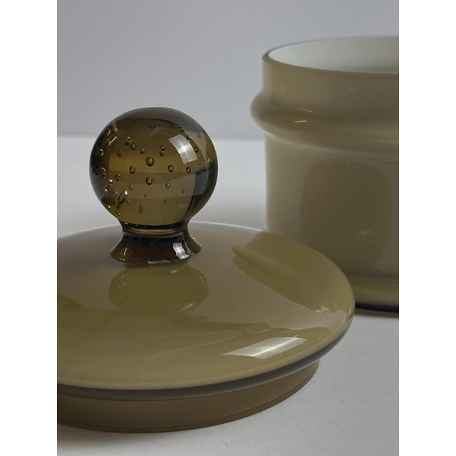 A cased brown Empoli glass apothecary jar by Carlo Moretti, produced in Italy in the 1960s. The earthy tone of the brown...