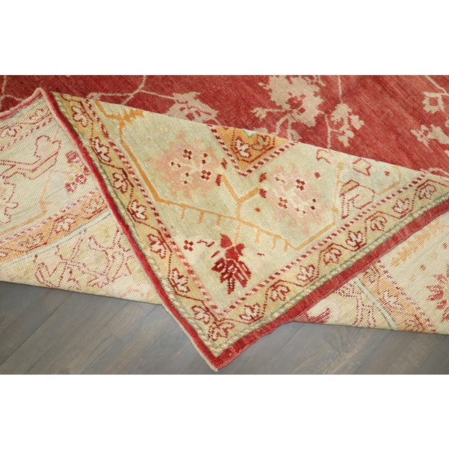 Exquisite early 20th century Turkish Oushak rug with a red background and ivory and gold central medallion and border....