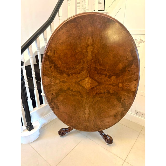 A highly impressive Victorian burr walnut dining table of elegant oval form, the top beautifully veneered in richly...