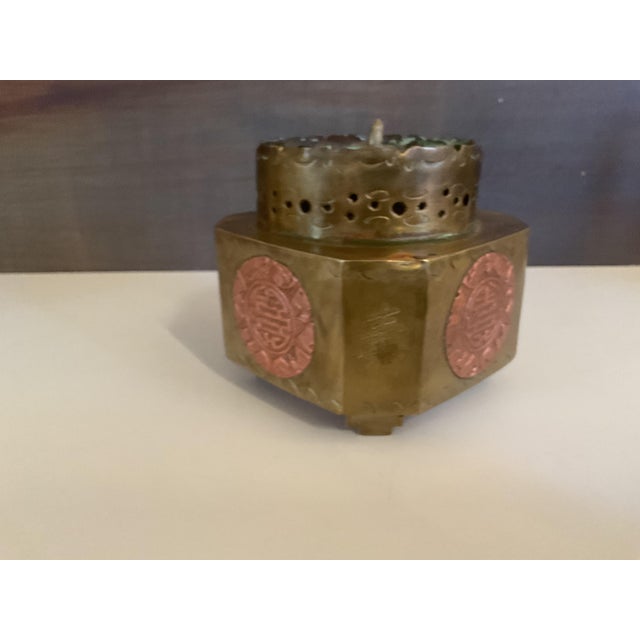 A beautifully crafted vintage brass incense burner featuring a mixed‑metal design with a raised copper medallion...