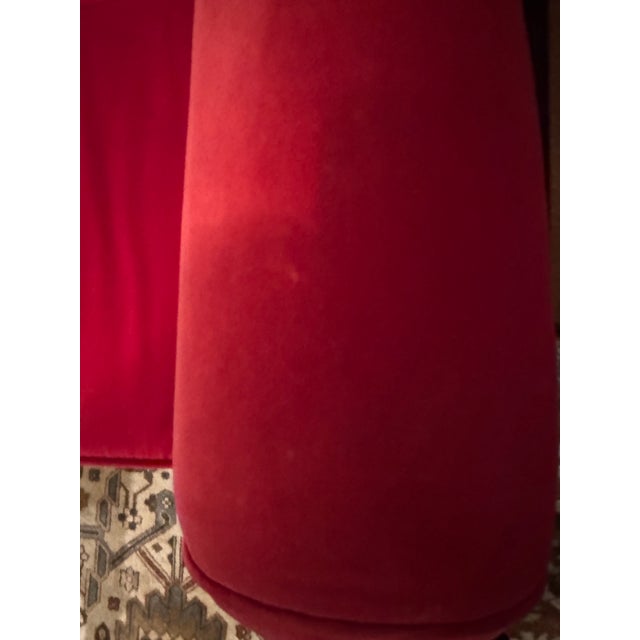 Striking red velvet armchair with scrolled arms and gold tapered legs. Dramatic, flared out high back silhouette makes it...