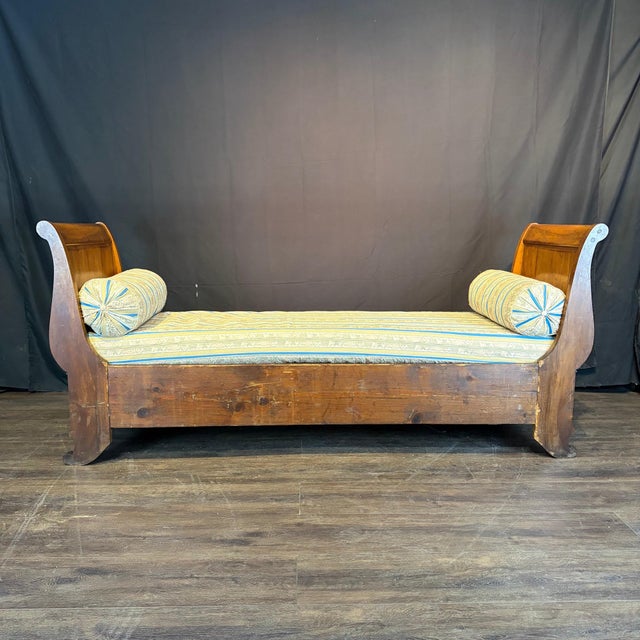 Elegant early 19th century French lit de repos with a richly figured wood frame and distinctive outscrolled ends. The long...