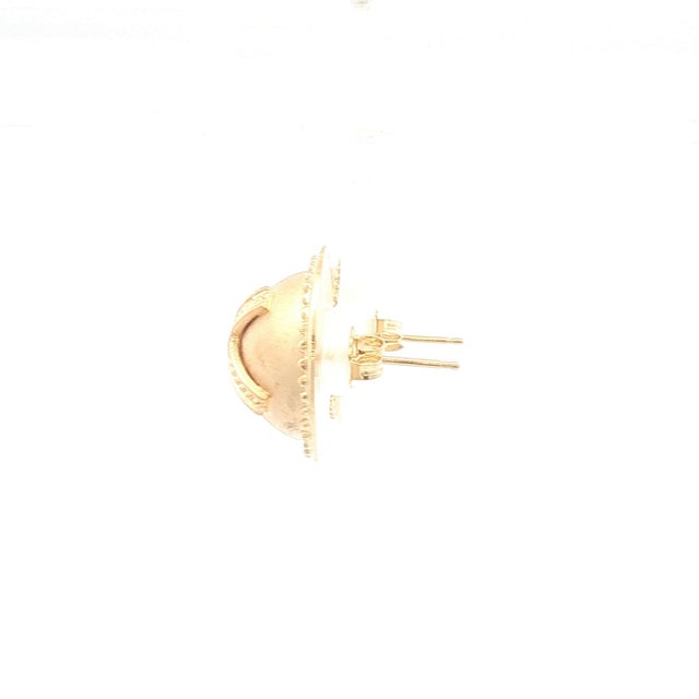 A pair of 14k gold earrings. Circular design with an embossed X pattern. Beaded border detail. In great condition. Height...