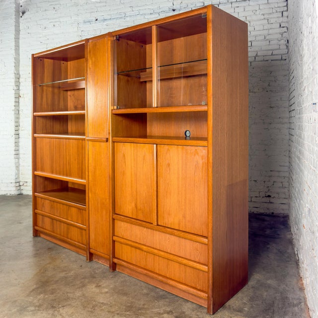 Handsome vintage Scandinavian Modern 3-piece display cabinet or storage wall unit composed of a lighted teak frame, 3...